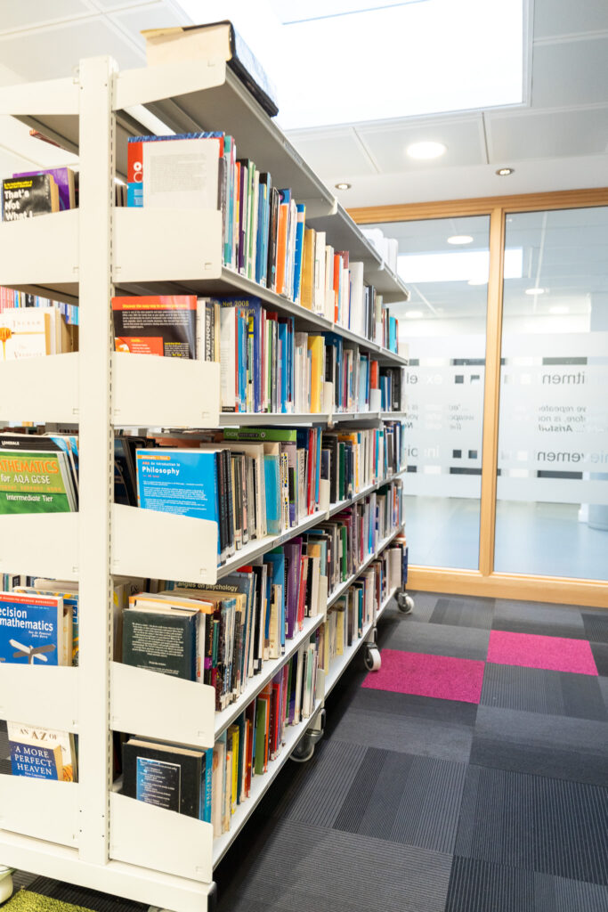 Extended project qualification (EPQ) - Library shelves of books beside a study area