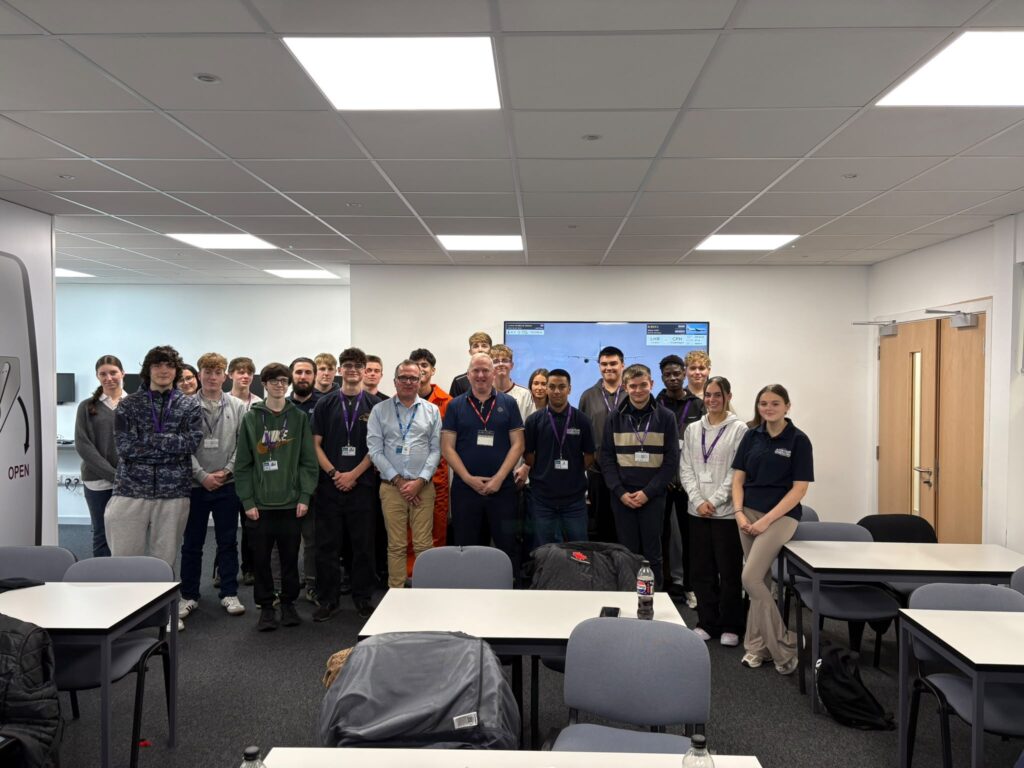 Aviation Operations students and staff in a group photo in a classroom.