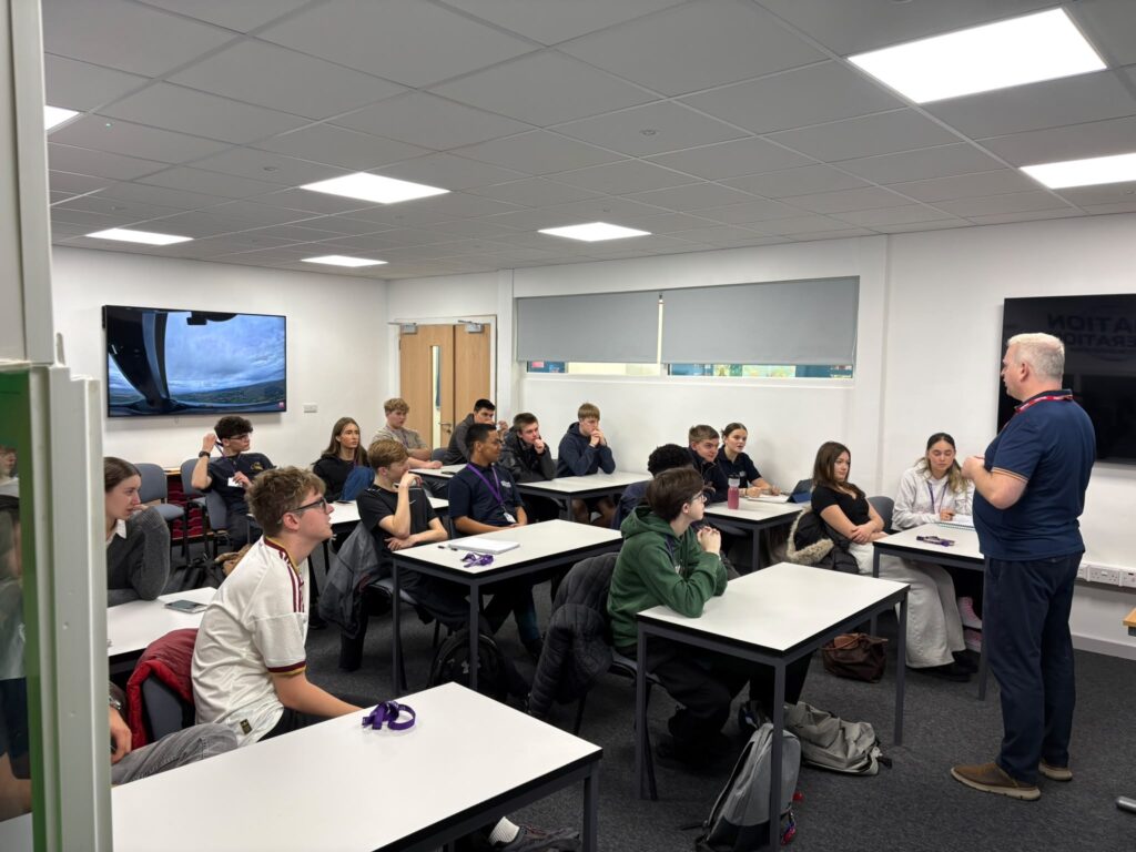 A trainer leads a classroom session with Aviation Operations students.